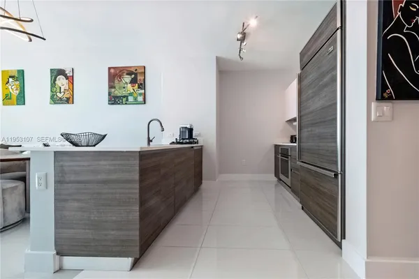 a kitchen with a refrigerator and cabinets