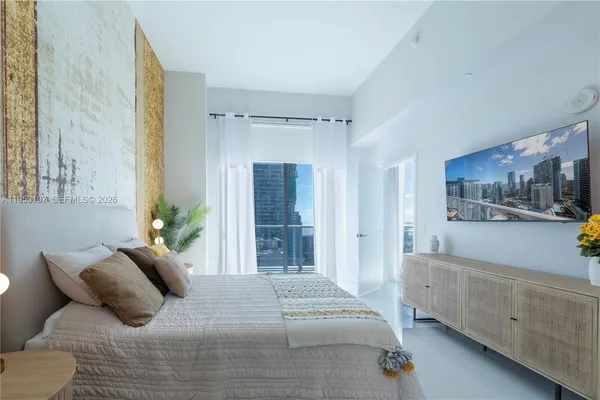 a bedroom with a large bed and a view of bedroom