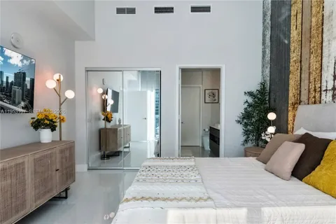 a bedroom with a bed and a couch