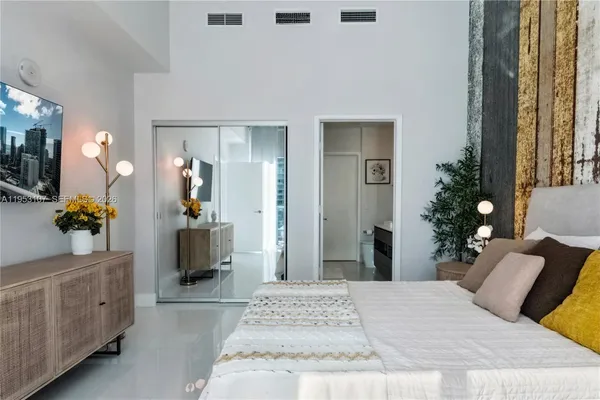 a bedroom with a bed and a couch