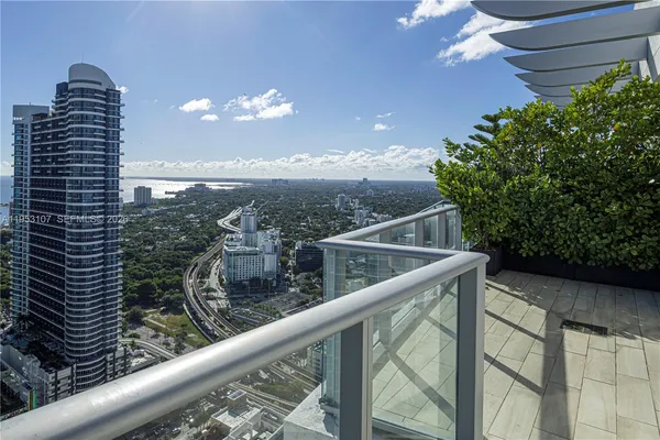 a view from a balcony with furniture