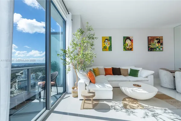 a living room with furniture and a potted plant