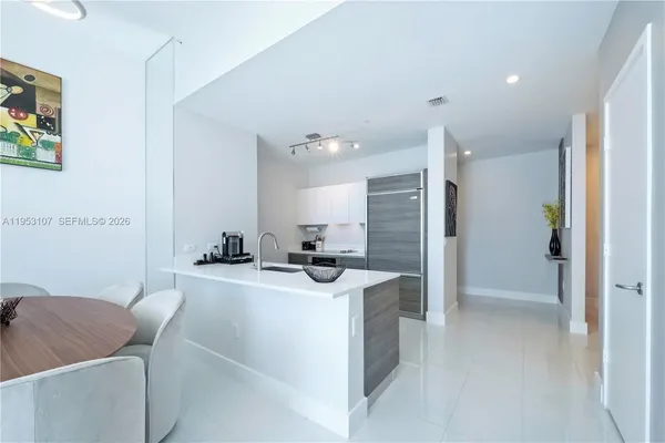 a room with a sink a washer and dryer