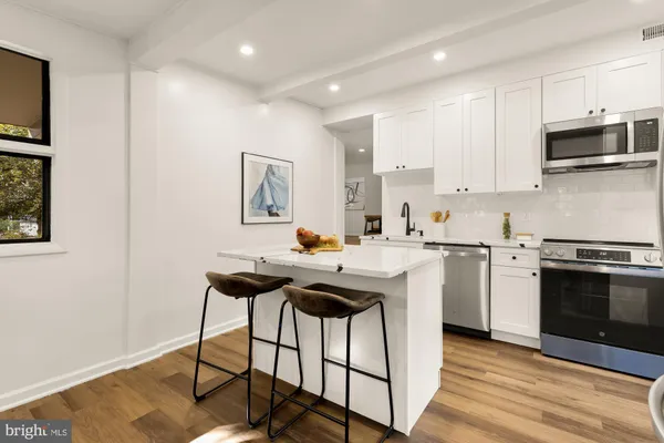 a kitchen with a stove a sink and a microwave