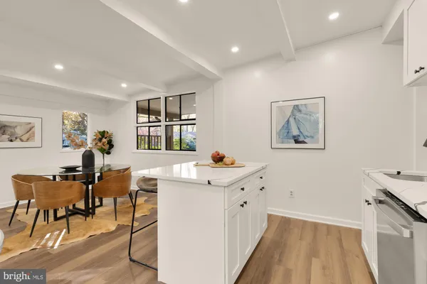 a view of a workspace room with wooden floor and furniture