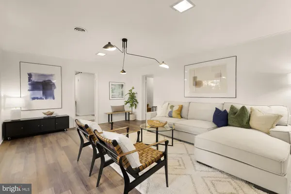 a living room with furniture and wooden floor