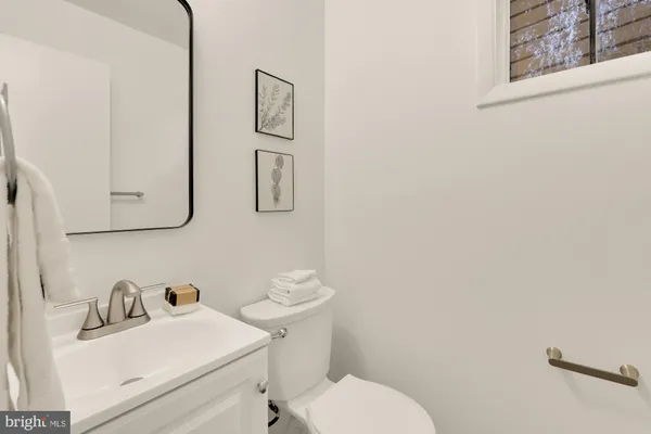 a bathroom with a sink mirror and toilet