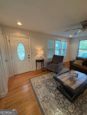 a living room with furniture a rug and a window