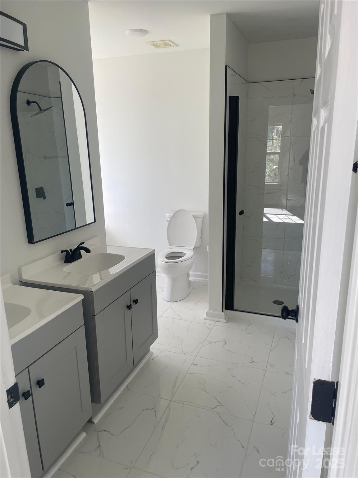 242 Amir Circle Matthews, NC 28105 - Photo 12 of 22 a bathroom with a toilet sink and mirror