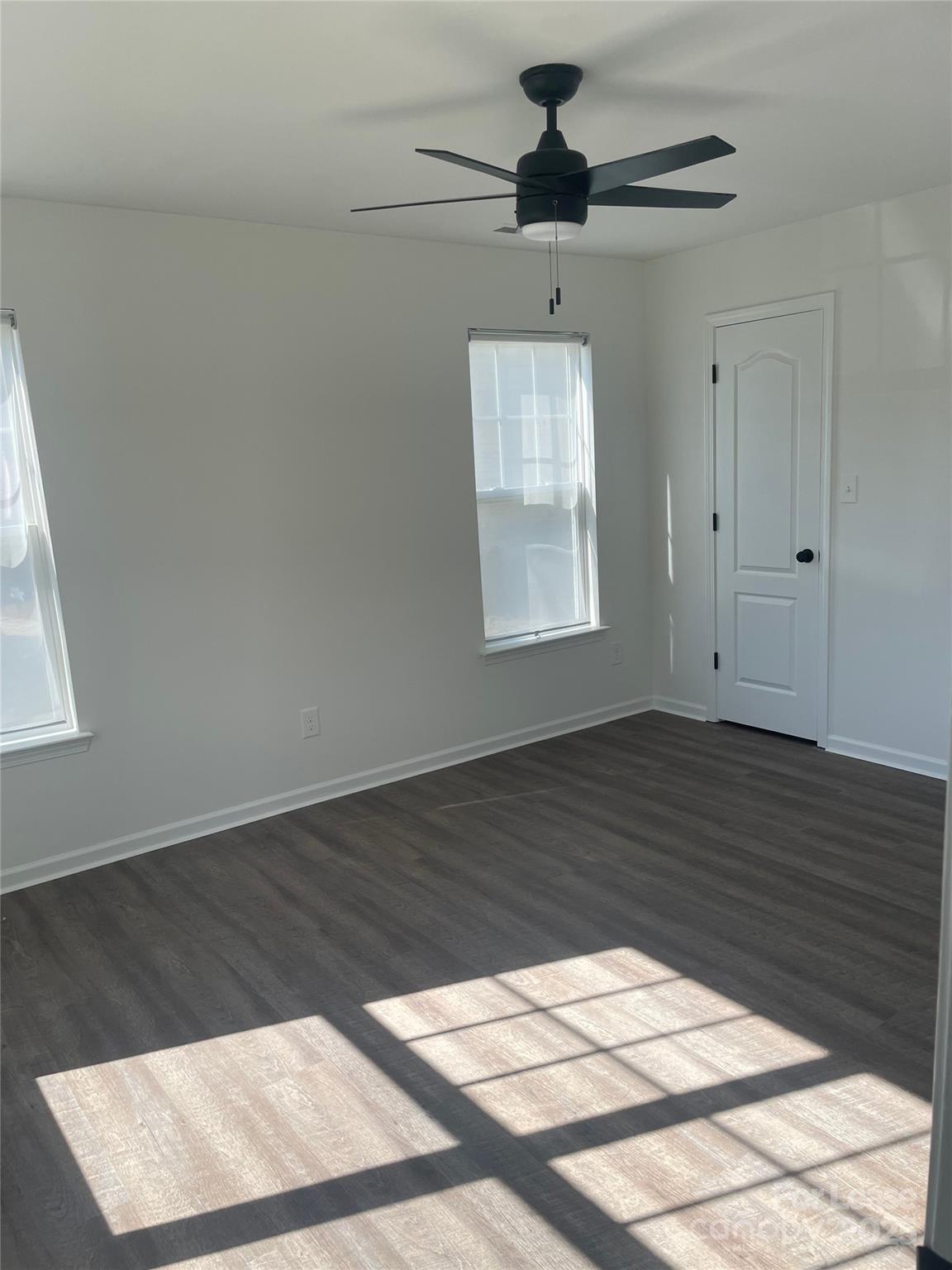 242 Amir Circle Matthews, NC 28105 - Photo 13 of 22 a view of an empty room with wooden floor and a window