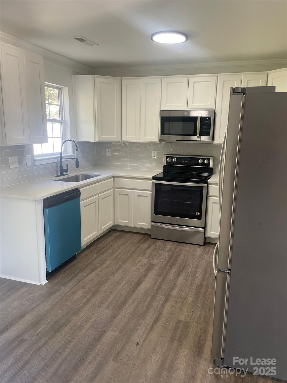 242 Amir Circle Matthews, NC 28105 - Photo 20 of 22 a kitchen with wooden cabinets and stainless steel appliances