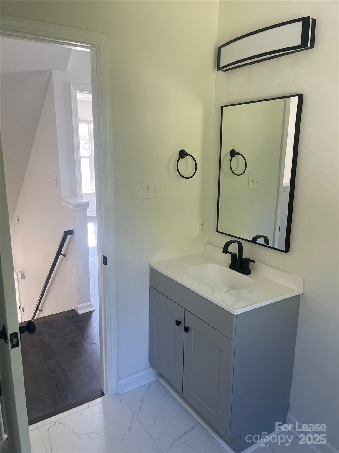 242 Amir Circle Matthews, NC 28105 - Photo 6 of 22 a bathroom with a sink a toilet and mirror