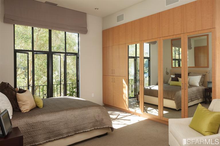 2330 Lyon Street San Francisco, CA 94115 - Photo 8 of 27 Master Wing: Two full bedrooms each have built-in desks, deluxe granite bathrooms, and abundant storage and spacious closets, and a vault. Note the electric shades, a TV set is discretely hidden behind cabinet doors.The second bedroom is presently furnished as a sitting room. It has a marble fireplace, and the bathroom has an extra large bathtub and steam shower. Both bathrooms have TV’s and built-in speakers.