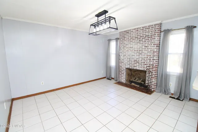 a view of an empty room and fire place
