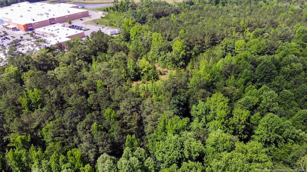 24-87 Nc Cameron, NC 28326 - Photo 21 of 28 an aerial view of residential house with outdoor space and trees all around