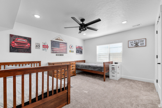 1426 South 1450th Street West Mapleton, UT 84664 - Photo 20 of 50 Spacious room featuring neutral carpeting, a ceiling fan with integrated lighting, recessed lighting, and a window with blinds