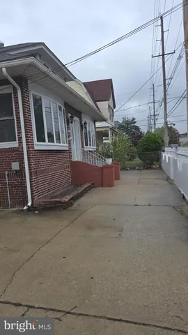 a view of a brick house with a yard