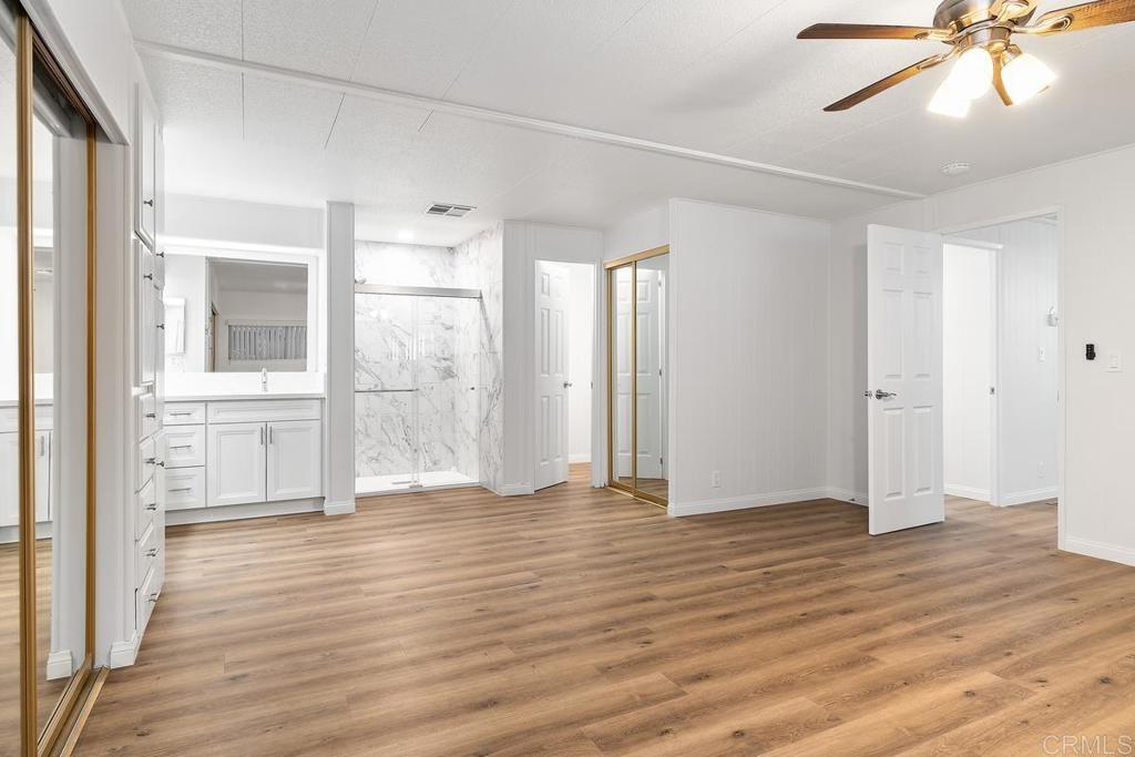 7467 Mission Gorge Road, Unit SPC 10 Santee, CA 92071 - Photo 24 of 44 a view of an empty room with wooden floor and a window