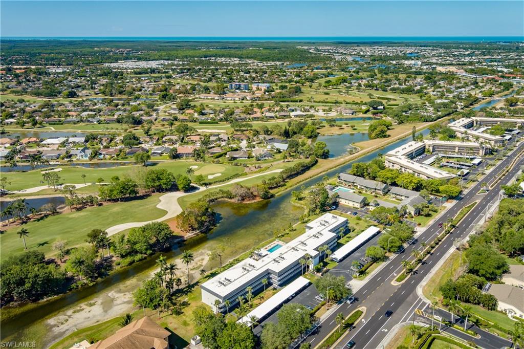 5515 Rattlesnake Hammock Road, Unit 205 Naples, FL 34113 - Photo 37 of 46 Drone / aerial view featuring a water view