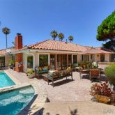 a view of a house with swimming pool and sitting area