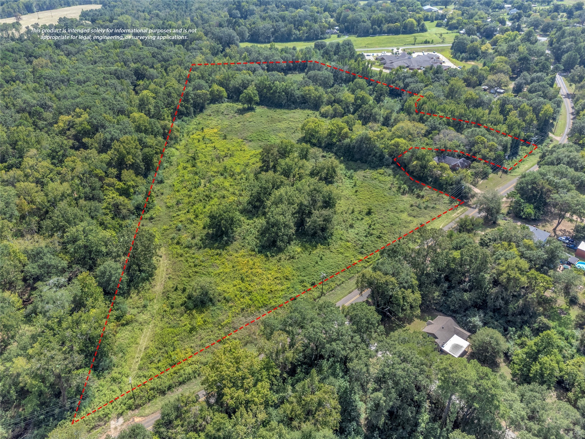 an aerial view of residential house with outdoor space and trees all around