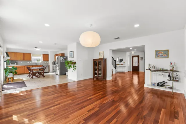 a view of a living room kitchen with furniture and wooden floor