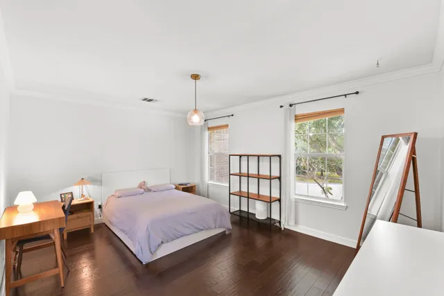 a spacious bedroom with a bed and a window