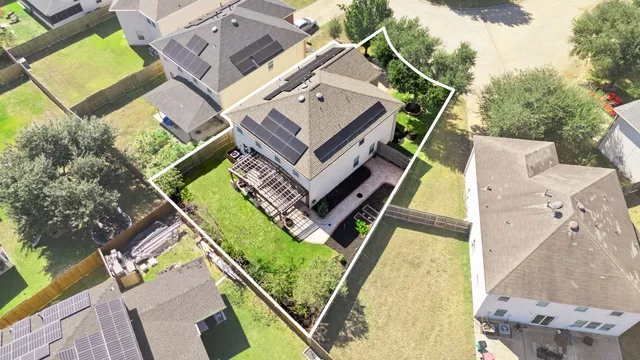 an aerial view of a house with a garden