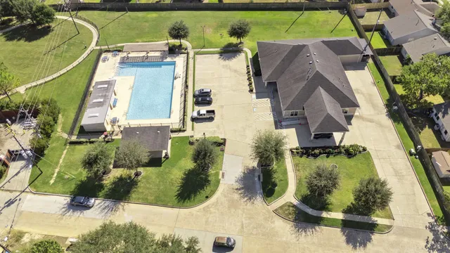 an aerial view of a residential apartment building with a yard
