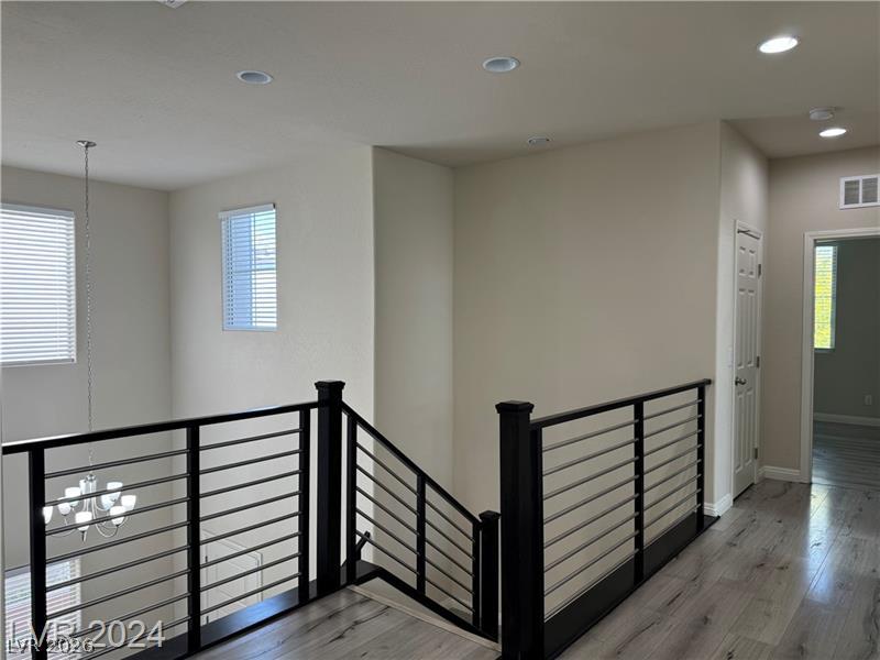 9056 Tony Ridge Avenue Las Vegas, NV 89148 - Photo 9 of 32 Clean lines and modern railings define this versatile interior space, perfect for contemporary living.