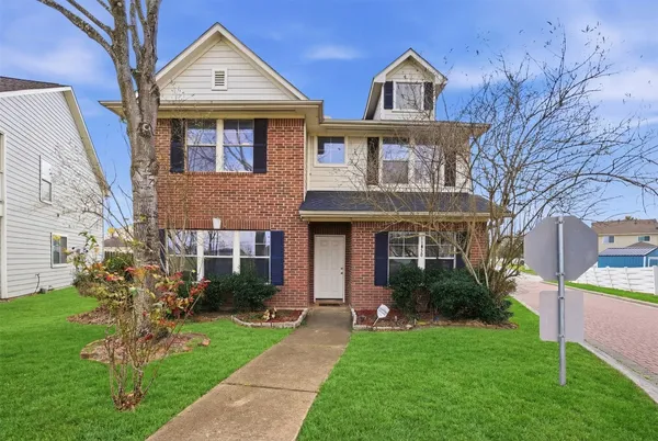 a front view of a house with a garden and plants