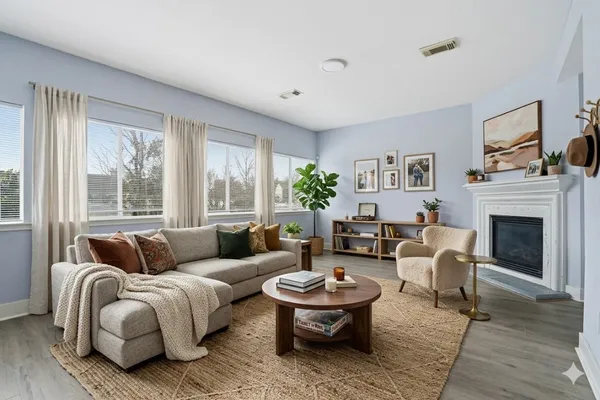 a living room with furniture and a fireplace