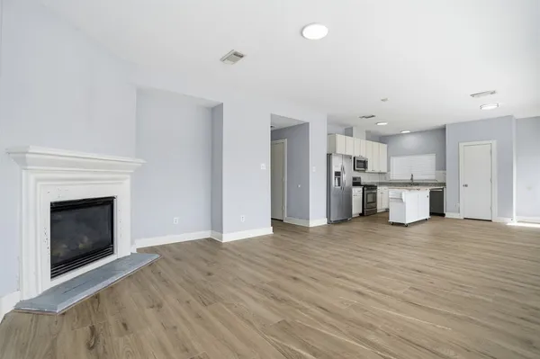 a view of a kitchen with a sink and a fireplace