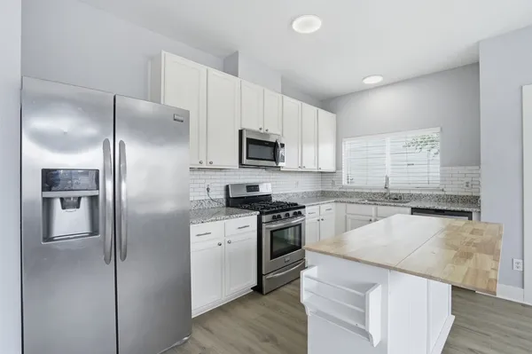 a kitchen with a refrigerator stove and microwave