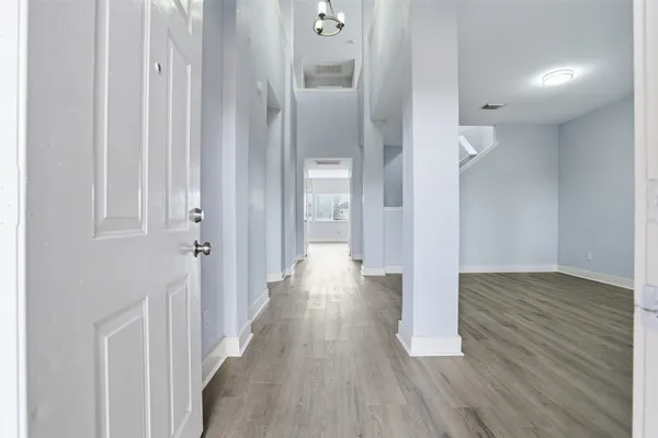 a view of a hallway with wooden floor