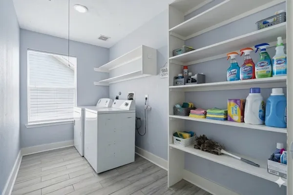 a room with a wooden floor and cabinets