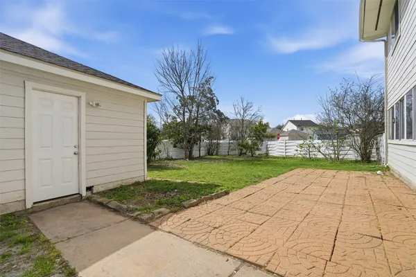 a view of backyard of house with green space