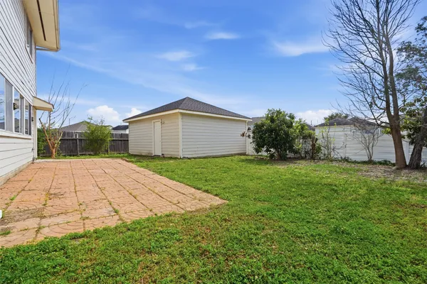 a view of backyard of house with green space