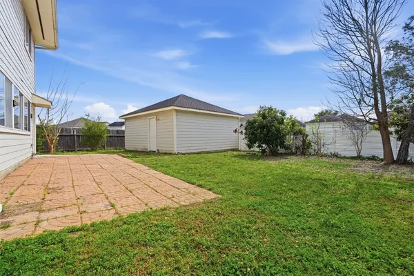 a view of backyard of house with green space