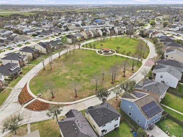 an aerial view of residential houses with outdoor space and river