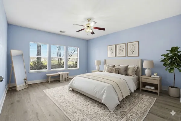 a bedroom with a large bed and a chandelier