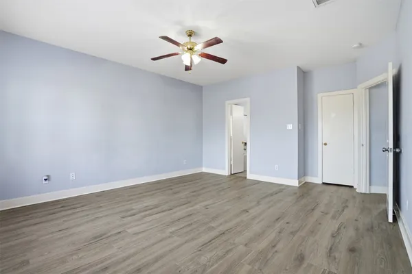 a view of an empty room with wooden floor