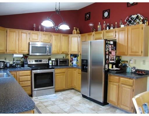 178 Palmer Road Brimfield, MA 01010 - Photo 7 of 17 a kitchen with stainless steel appliances granite countertop a refrigerator a stove top oven a sink and dishwasher