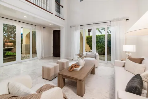 a dining room with furniture and a window