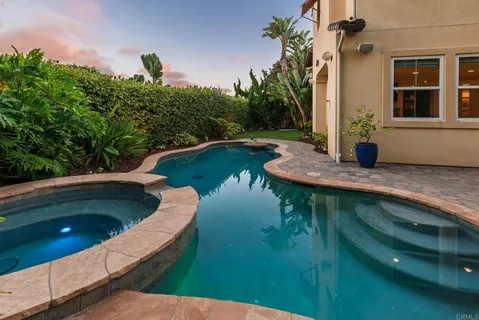 a view of a swimming pool with a yard
