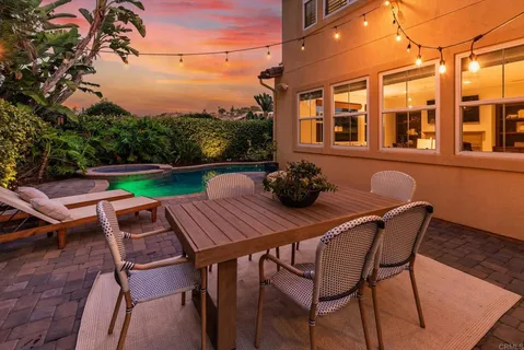 a view of a patio with table and chairs and potted plants