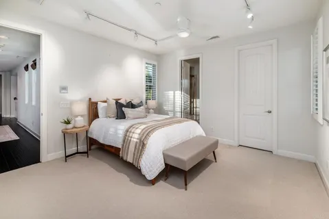a spacious bedroom with a bed and a couch