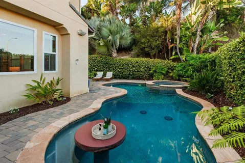 a view of a swimming pool in back of a house
