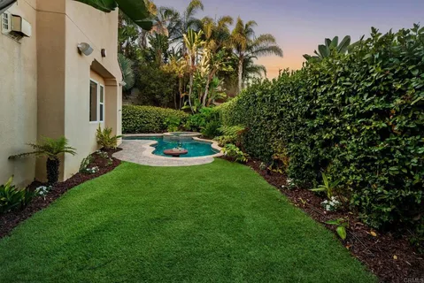 a swimming pool with outdoor seating and yard