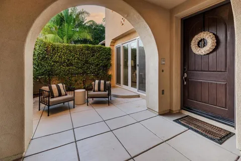 a view of a porch with furniture and a gate